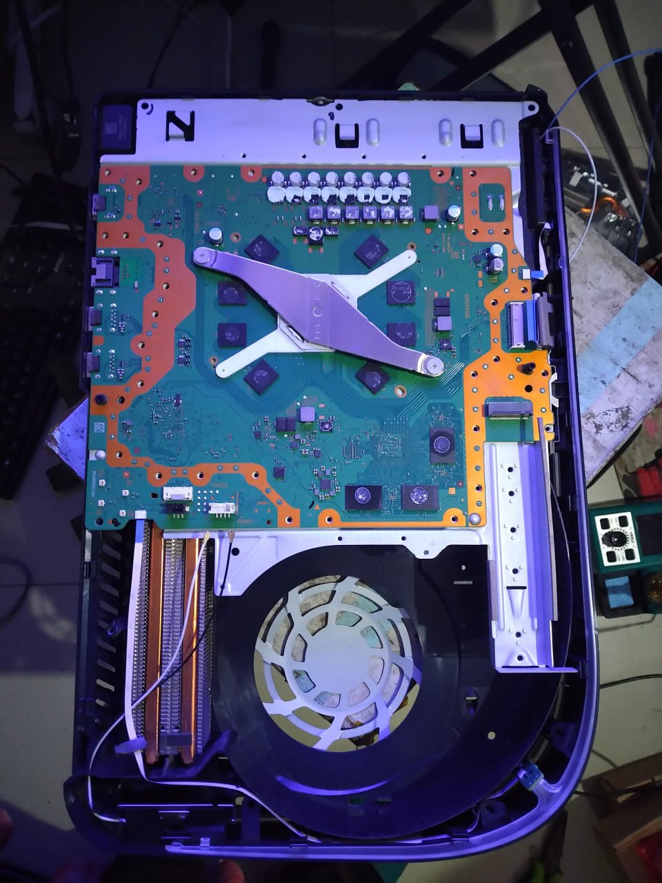 Opened PS5 console showing internal repair work